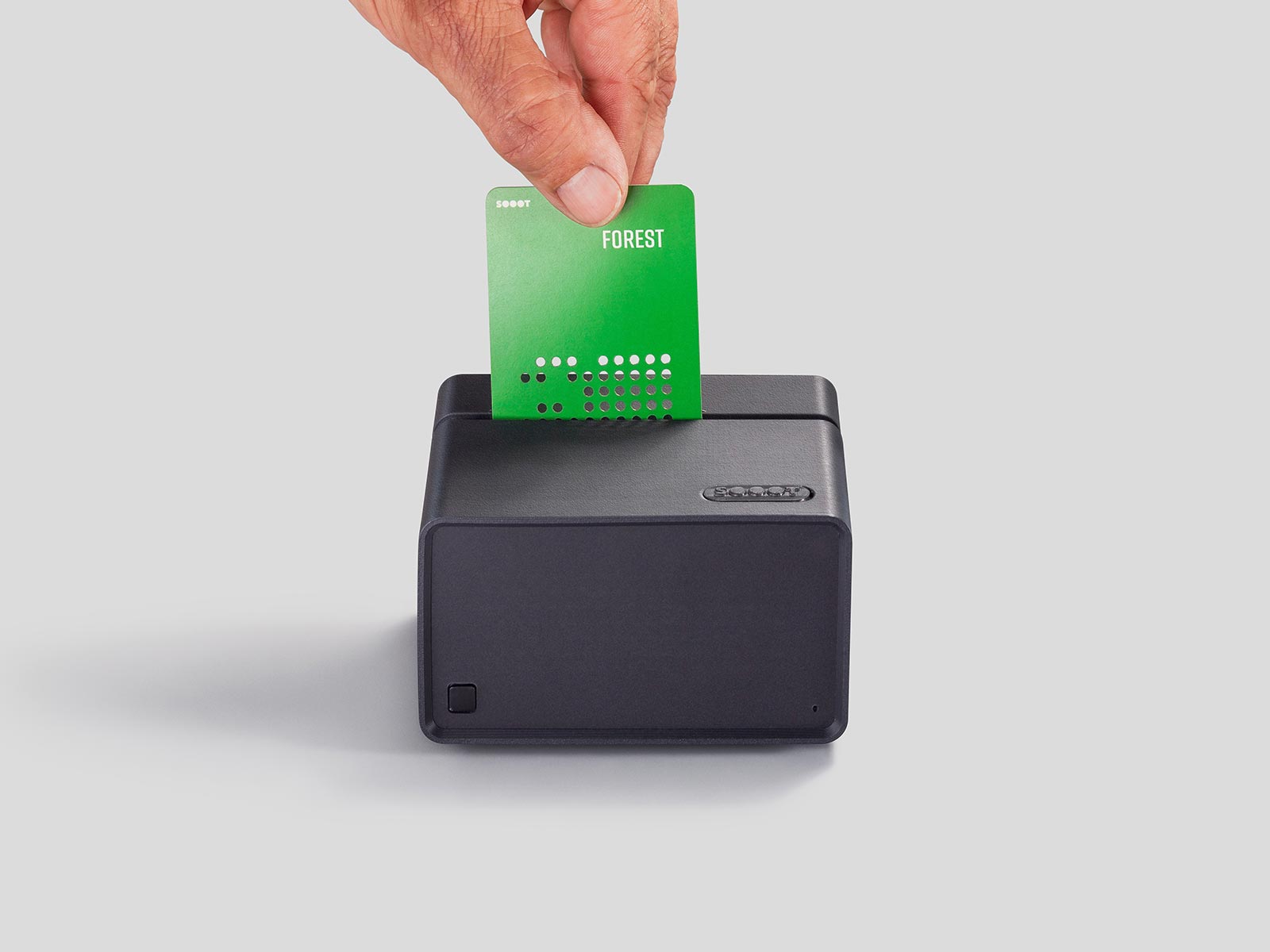 A hand inserts a green FOREST card into the slot of the SOOOT Box
